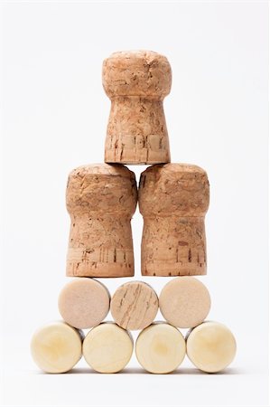 simsearch:400-04892457,k - Pyramid made of bottle cork stoppers on white Fotografie stock - Microstock e Abbonamento, Codice: 400-06075865