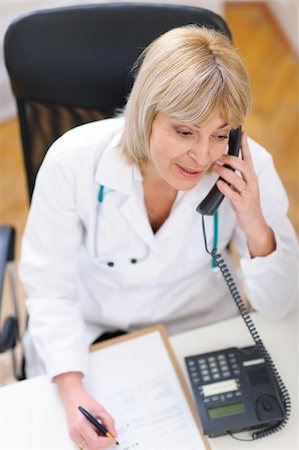 Senior doctor speaking phone Stock Photo - Budget Royalty-Free & Subscription, Code: 400-06076039