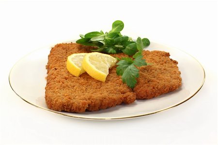 Viennese-style schnitzel with lemon and parsley Stock Photo - Budget Royalty-Free & Subscription, Code: 400-06076527