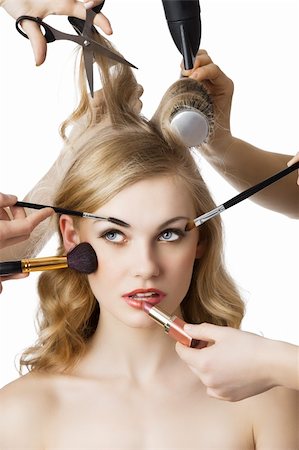 salon set - woman getting a beauty and hair style in the same time with hands making differente works, she is in front of the camera and looks up at right Stock Photo - Budget Royalty-Free & Subscription, Code: 400-06076605