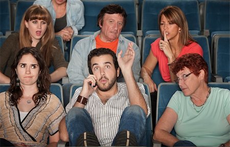 Loud bearded man on phone annoys the audience in theater Stock Photo - Budget Royalty-Free & Subscription, Code: 400-06076666