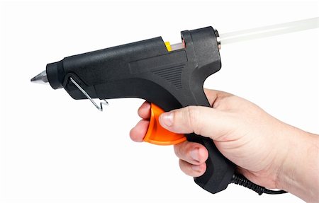 Electric hot glue gun in hand isolated on a white background. Photographie de stock - Aubaine LD & Abonnement, Code: 400-06077176