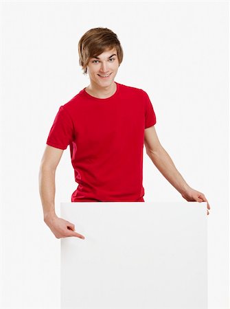 simsearch:400-05368656,k - Portrait of a happy young man showing something on a blank white card Stockbilder - Microstock & Abonnement, Bildnummer: 400-06077635