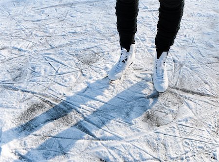 simsearch:400-05091082,k - woman standing on white skates on a snowy ice floor Photographie de stock - Aubaine LD & Abonnement, Code: 400-06077711