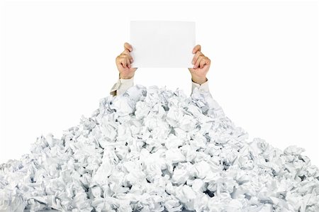paper waste in office - Person under crumpled pile of papers with hand holding a blank page / isolated on white Stock Photo - Budget Royalty-Free & Subscription, Code: 400-06077867