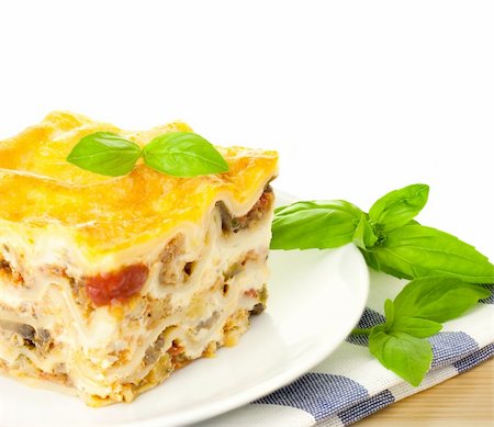 simsearch:400-07972143,k - Delicious Italian Lasagna / with fresh basil / white background and copy spase Photographie de stock - Aubaine LD & Abonnement, Code: 400-06077878