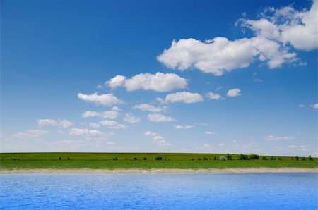 water and green field under deep blue cloudy sky Photographie de stock - Aubaine LD & Abonnement, Code: 400-06078239