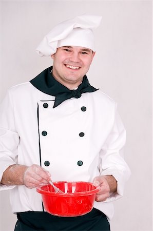 simsearch:400-06078465,k - smiling chef mixes the dough in a bowl Stock Photo - Budget Royalty-Free & Subscription, Code: 400-06078464