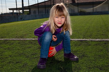 Little girl sitting on a basketball on an outdoor court Stock Photo - Budget Royalty-Free & Subscription, Code: 400-06070016