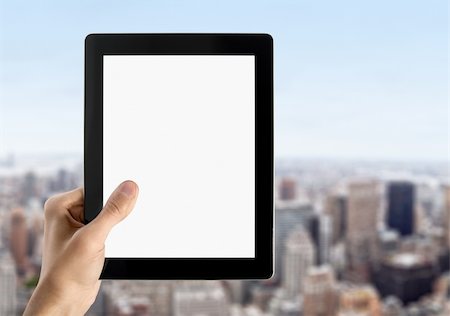 Man hands are holding touch screen device with blank screen. Blurred cityscape with skyscrapers on background. Stock Photo - Budget Royalty-Free & Subscription, Code: 400-06070117