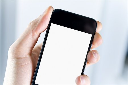 symbol for intelligence - A man holding smartphone with blank screen in hand. Closeup shot. Stock Photo - Budget Royalty-Free & Subscription, Code: 400-06070113