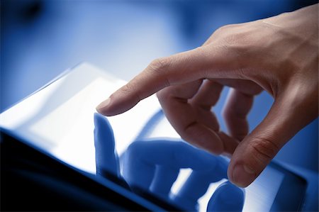 Man hand touching screen on modern digital tablet pc. Close-up image with shallow depth of field focus on finger. Stock Photo - Budget Royalty-Free & Subscription, Code: 400-06070131