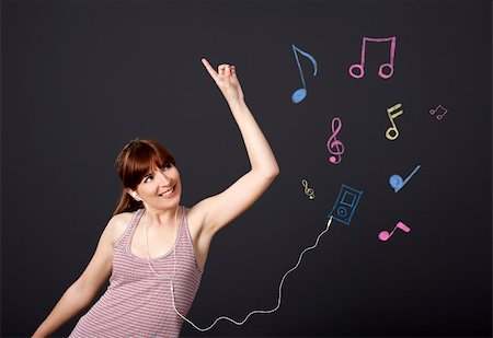 simsearch:400-05717354,k - Young woman dancing and listen music with musical notes drawn with chalk on a black wall Stock Photo - Budget Royalty-Free & Subscription, Code: 400-06070476