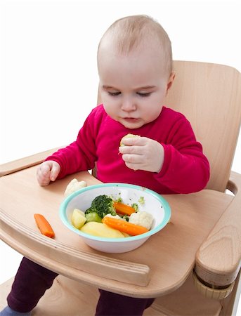 young child in red shirt eating vegetables in wooden chair. Stock Photo - Budget Royalty-Free & Subscription, Code: 400-06070666