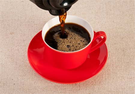 Red coffee cup filled with black expresso on canvas Fotografie stock - Microstock e Abbonamento, Codice: 400-06070709