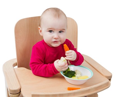 young child in red shirt eating vegetables in wooden chair. Stock Photo - Budget Royalty-Free & Subscription, Code: 400-06070945