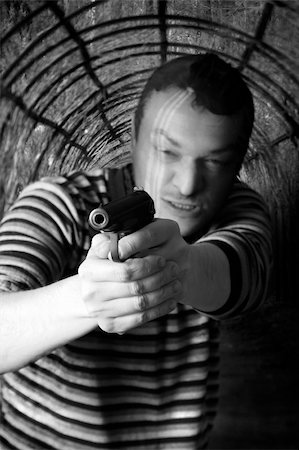 simsearch:400-07097770,k - Black dressed man with gun in the tunnel Photographie de stock - Aubaine LD & Abonnement, Code: 400-06071078
