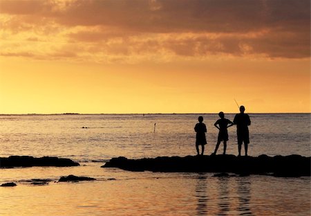 simsearch:400-05271777,k - Three young fishermen are on the beach at sunset. Stock Photo - Budget Royalty-Free & Subscription, Code: 400-06071072