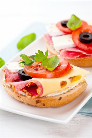 plate of cold cuts and cheeses - sandwiches with salami, camembert cheese, tomato and olives Stock Photo - Budget Royalty-Free & Subscription, Code: 400-06071136