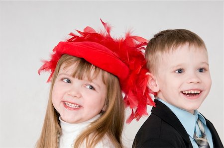 smiling boy and a girl is stand back to back Stock Photo - Budget Royalty-Free & Subscription, Code: 400-06072667