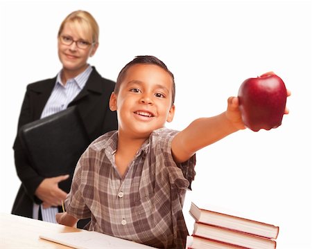 simsearch:400-04125503,k - Hispanic Student Boy At Desk with Apple and Female Adult Behind. Photographie de stock - Aubaine LD & Abonnement, Code: 400-06072950