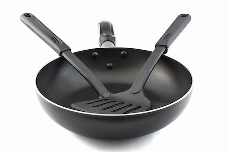 sauteeing - Pan with handle and Spade of frying pan on white background Photographie de stock - Aubaine LD & Abonnement, Code: 400-06073000