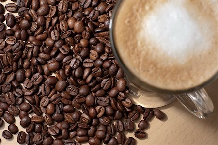 simsearch:400-05260473,k - Coffee with froth and coffee beans below on the table.  Lens focus on beans. Foto de stock - Super Valor sin royalties y Suscripción, Código: 400-06073115