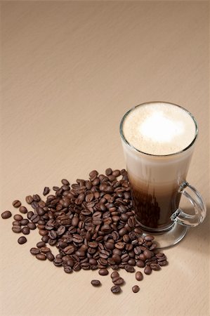 simsearch:400-05260473,k - Coffee with froth and coffee beans below on the table. Vertical Foto de stock - Super Valor sin royalties y Suscripción, Código: 400-06073113