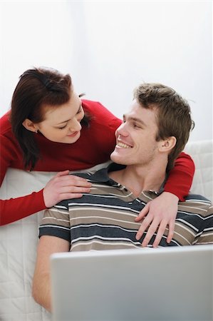 Girl pulling attention of boyfriend from laptop to herself Stock Photo - Budget Royalty-Free & Subscription, Code: 400-06086358