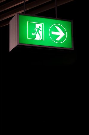 dark people running - Emergency exit sign in modern offices inside an industrial plant Stock Photo - Budget Royalty-Free & Subscription, Code: 400-06086543