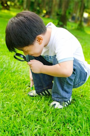 Little boy exploring nature by magnifier Stock Photo - Budget Royalty-Free & Subscription, Code: 400-06087206