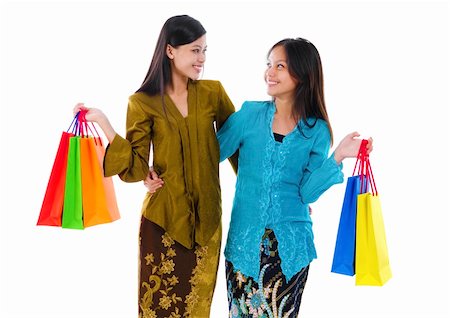 simsearch:400-06092781,k - Two mixed race Asian women holding shopping bags isolated on white background Photographie de stock - Aubaine LD & Abonnement, Code: 400-06087234