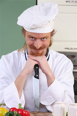 simsearch:400-04116514,k - Funny young chef with a knife in kitchen Stockbilder - Microstock & Abonnement, Bildnummer: 400-06087311