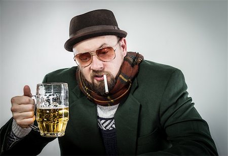 sad addiction pictures - A sad looking man at a bar top wearing a green sports coat and scarf. He is holding a half pint of lager and smoking a cigarette. It appears he is not very happy. Stock Photo - Budget Royalty-Free & Subscription, Code: 400-06087528