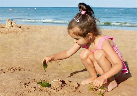 Little girl playing on the seaside Stock Photo - Budget Royalty-Free & Subscription, Code: 400-06087636