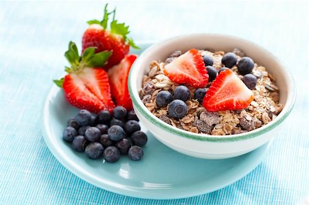 Bowl of muesli, strawberries and blueberries for healthy breakfast Stock Photo - Budget Royalty-Free & Subscription, Code: 400-06088357