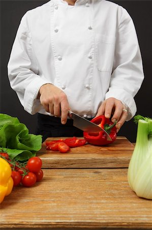 Photo of a chef chopping vegetables on a wooden cutting board. Stock Photo - Budget Royalty-Free & Subscription, Code: 400-06088410