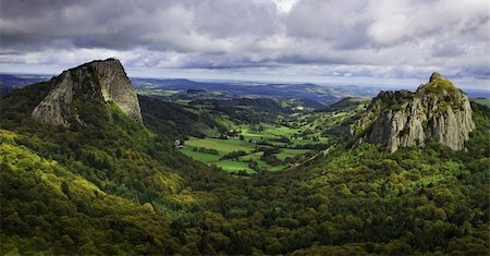 Beautiful rocky volcanic landscape in The Central Massif in France. The image represents The Tuiliere Rocks (left) and The Sanadoire Rocks (right) and between these there is The Chausse Valley. Stock Photo - Budget Royalty-Free & Subscription, Code: 400-06088617