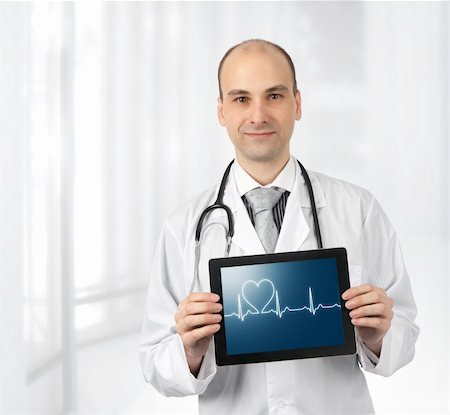 simsearch:400-04130714,k - Smiling doctor with hearts beat diagram on a tablet computer Photographie de stock - Aubaine LD & Abonnement, Code: 400-06089158