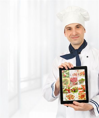 cook man showing a digital tablet with menu Stock Photo - Budget Royalty-Free & Subscription, Code: 400-06089162