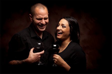 simsearch:400-06464550,k - Happy Young Mixed Race Couple Holding Wine Glasses Against A Black Background. Foto de stock - Super Valor sin royalties y Suscripción, Código: 400-06080073