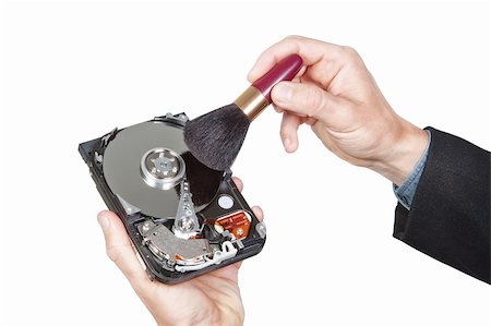 festplatte - Cleaning open hard disk with brush.On a white background. Stockbilder - Microstock & Abonnement, Bildnummer: 400-06080727