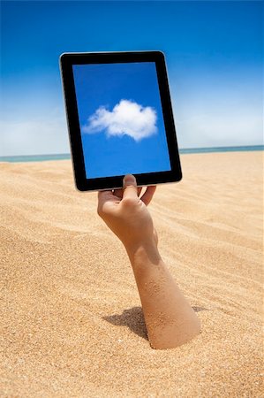 hand holding touch screen computer on the beach Stock Photo - Budget Royalty-Free & Subscription, Code: 400-06080735