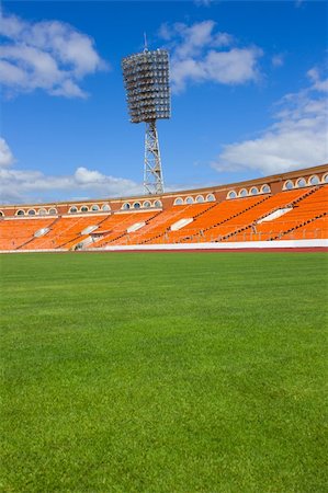 soccer field background - football field with light stand and orange seats Stock Photo - Budget Royalty-Free & Subscription, Code: 400-06081709