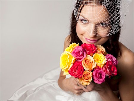 elegant bride hairstyle - pretty brunette wearing wedding dress on light background Foto de stock - Super Valor sin royalties y Suscripción, Código: 400-06082106