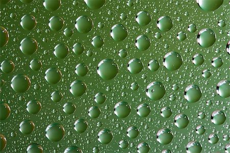 Close up of water drops on green glass surface as background Stock Photo - Budget Royalty-Free & Subscription, Code: 400-06082165