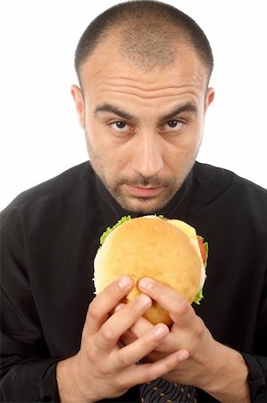 Young businessman eating hamburger over white Foto de stock - Super Valor sin royalties y Suscripción, Código: 400-06082848