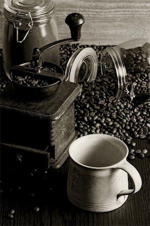 Photo of roasted coffee beans, coffee cup, antique grinder on a wooden table. Stock Photo - Budget Royalty-Free & Subscription, Code: 400-06082916