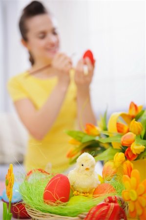 Closeup on basket of Easter eggs and woman painting on egg in background Stock Photo - Budget Royalty-Free & Subscription, Code: 400-06083096