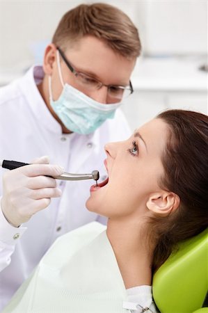 female with dental tools at work - The dentist treats teeth of the patient in the clinic Stock Photo - Budget Royalty-Free & Subscription, Code: 400-06083409